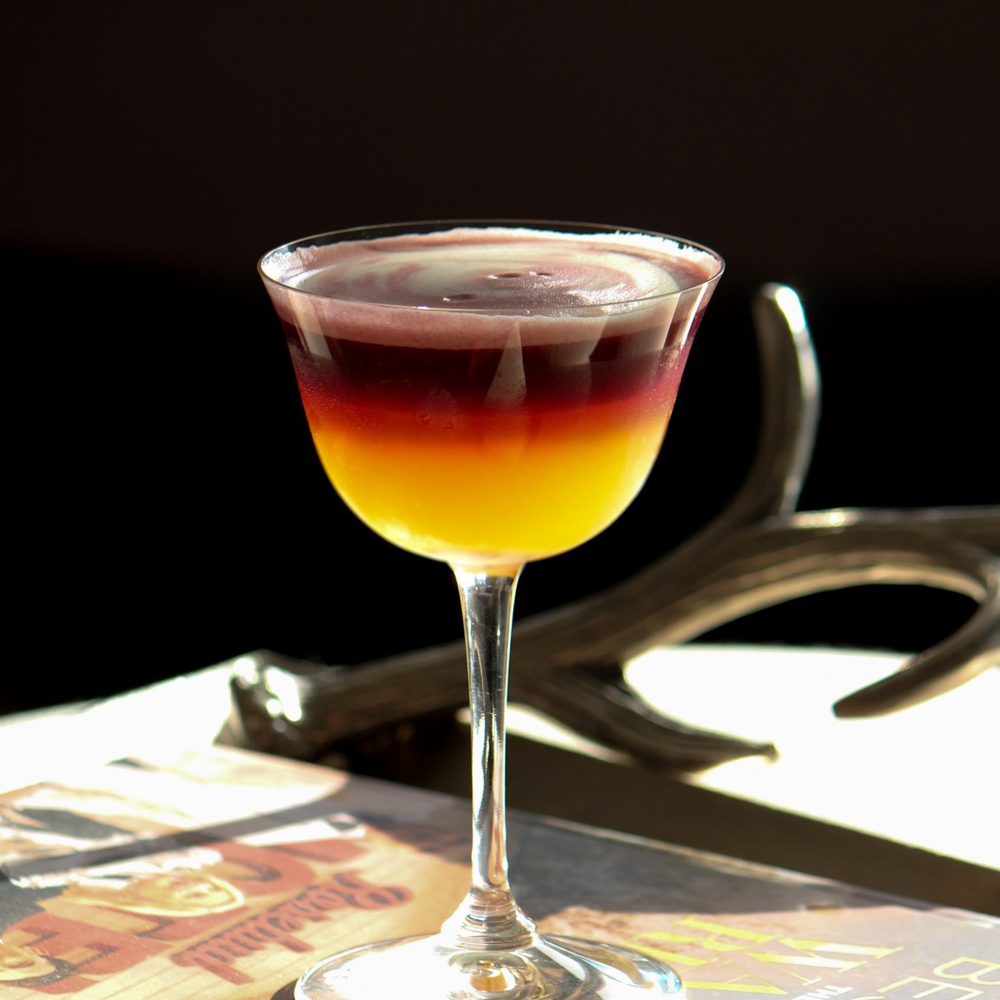 Craft cocktail with a citrus garnish, menu photography