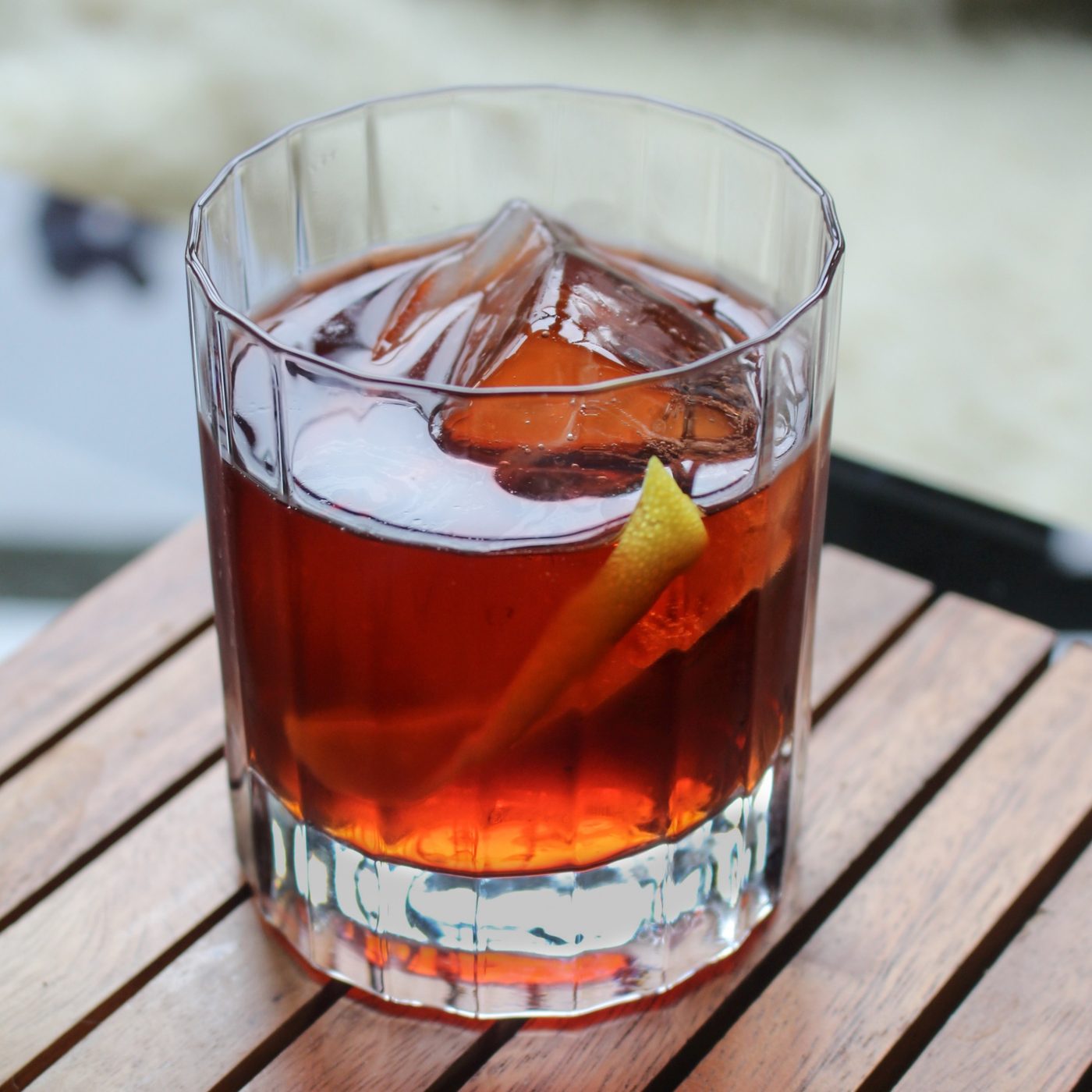 Old fashioned style cocktail with a large ice cube