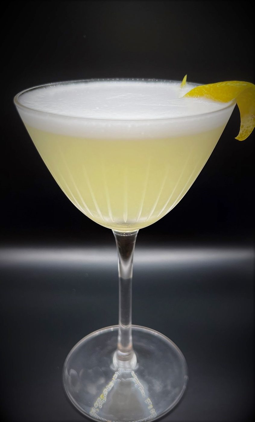 Frothy signature cocktail with a citrus twist