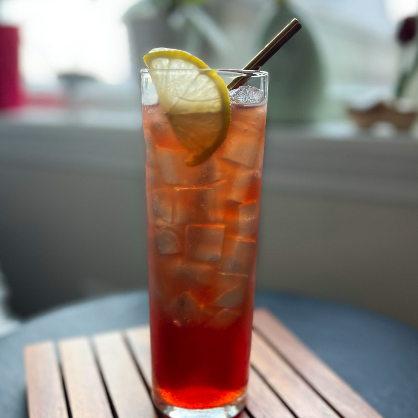 Craft cocktail served over ice with a lemon garnish