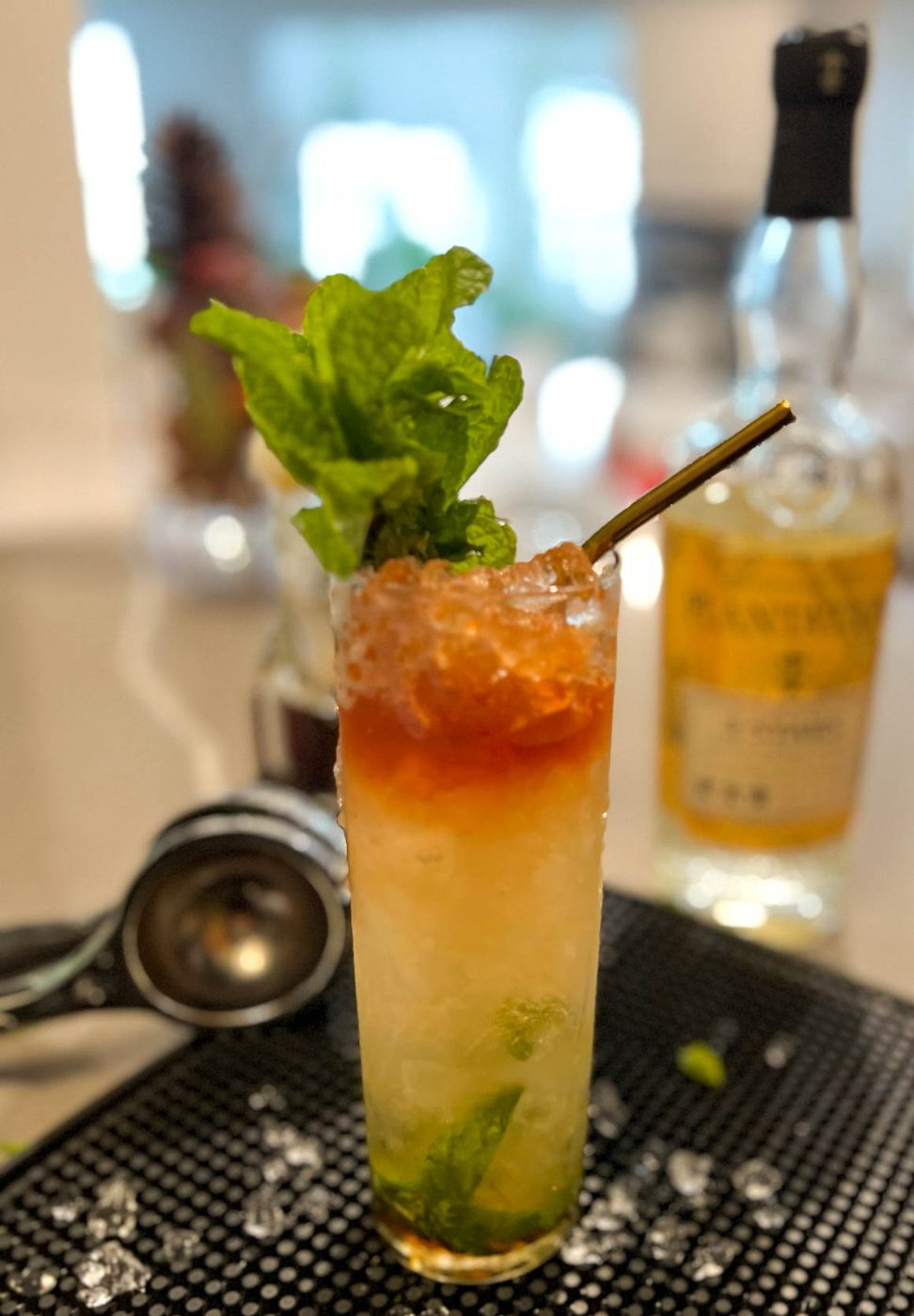 Craft mint julep style cocktail with a fresh sprig