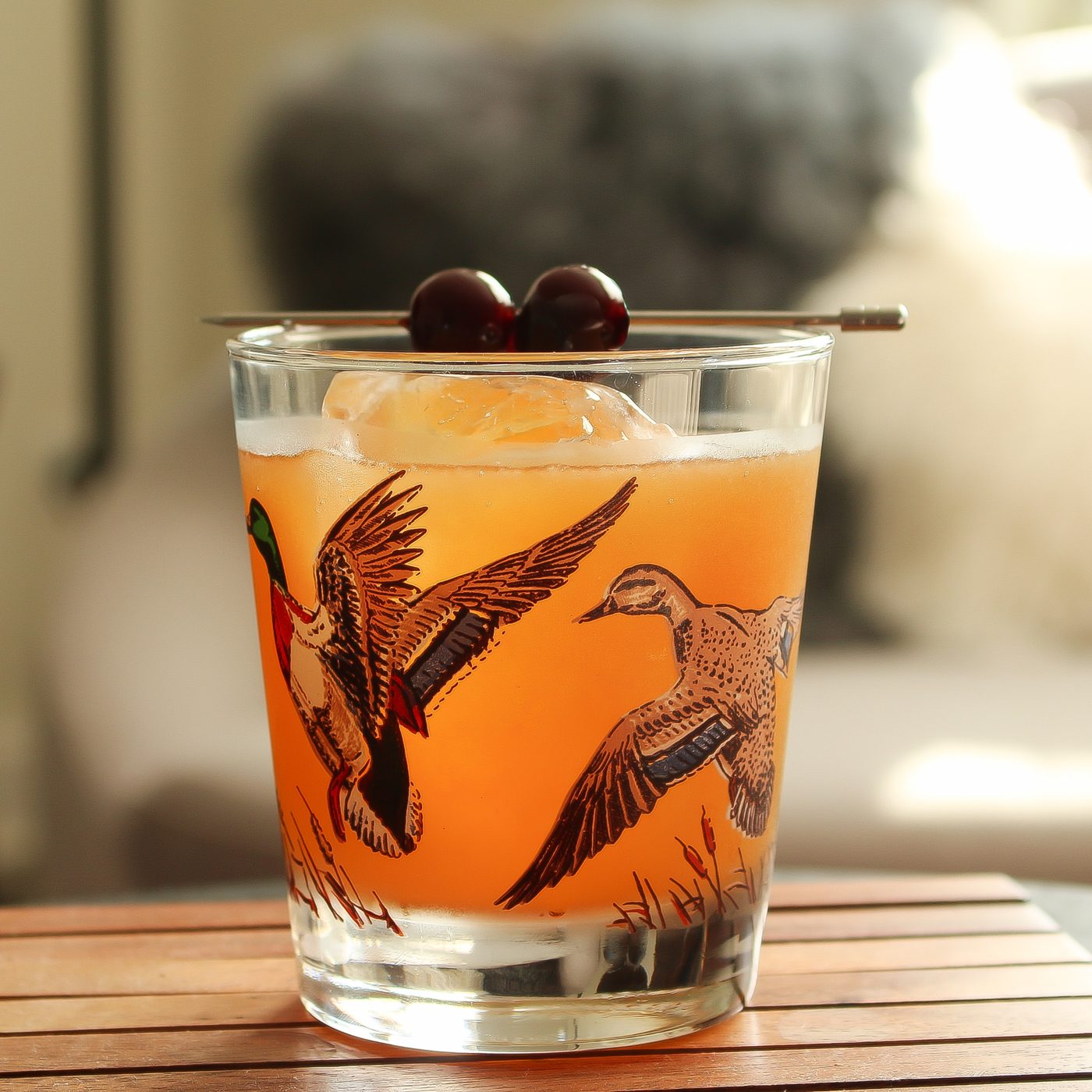 Signature cocktail served in a patterned glass with cherries