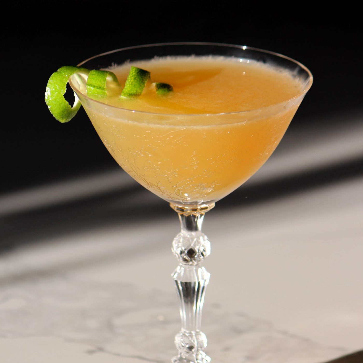 Craft cocktail with a lime wedge garnish