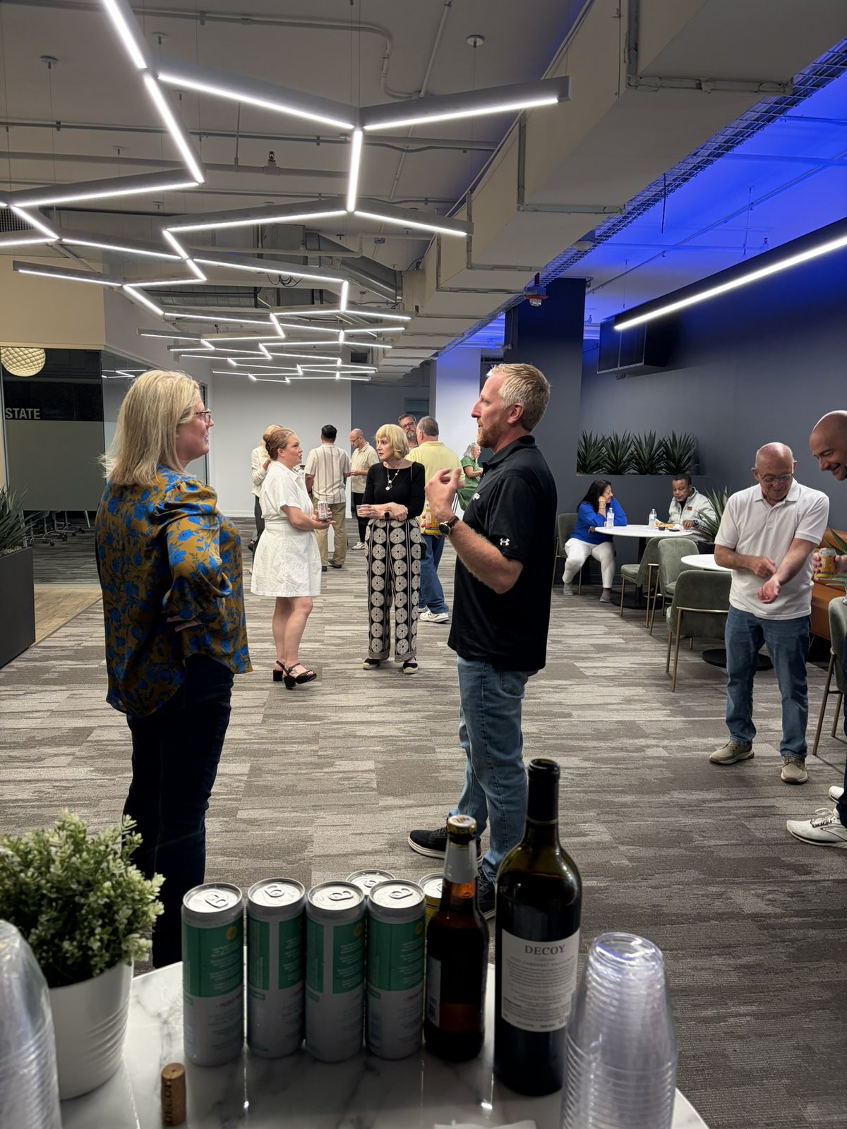 Bartender staffing a bar table at an indoor corporate mixer