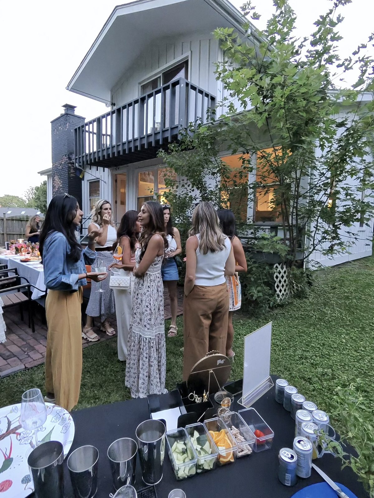 Guests mingling at a backyard private party bar in Chicagoland