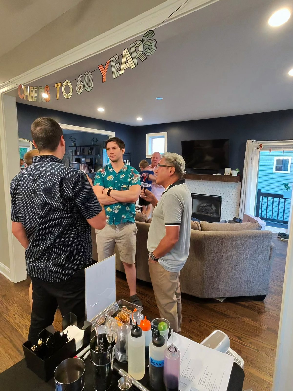 Milestone birthday celebration with a full bar setup and bar tools in the foreground