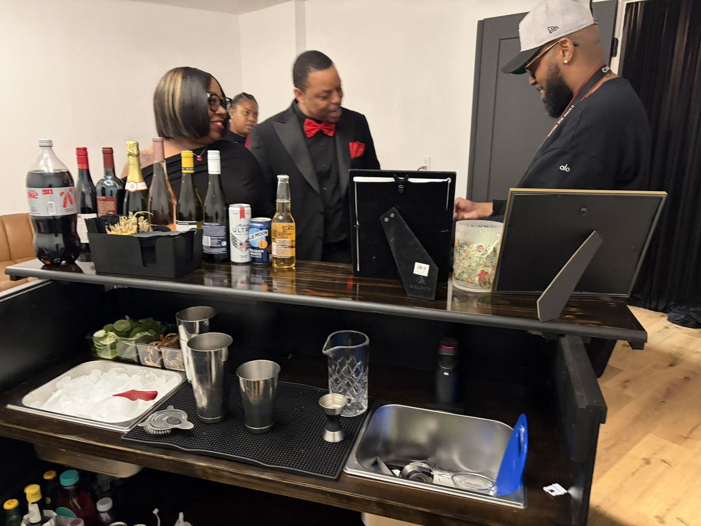 Guests gathered around the bar at a birthday celebration