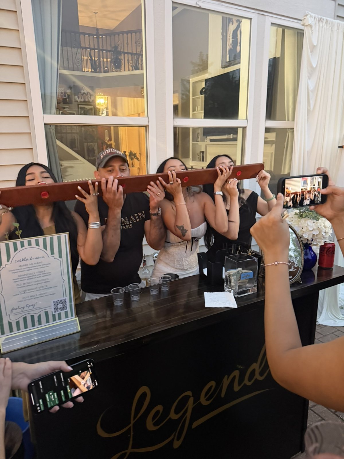Legend Mobile Bar's branded cart at a Chicagoland wedding, bridal party sharing a fun shot-ski toast