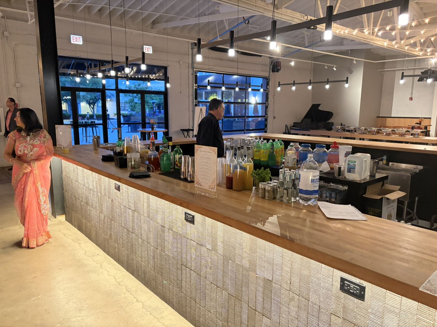Bartender pouring drinks at a wedding reception bar