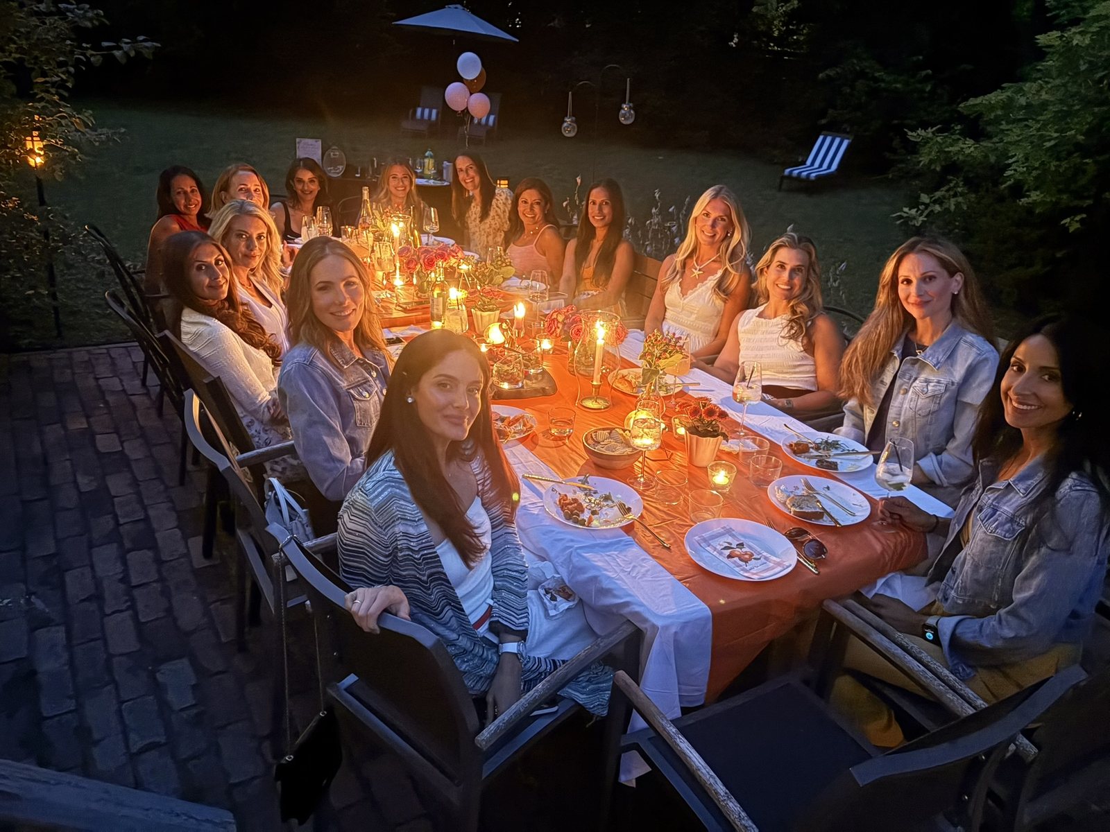 Candlelit outdoor dinner party with a guided wine pairing by a certified sommelier