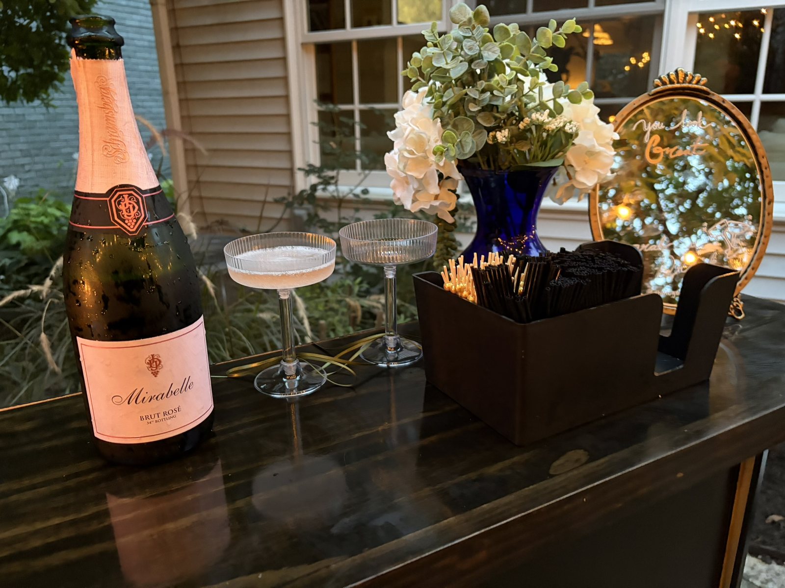 Champagne bottle, coupe glasses, and floral bar styling for a sommelier-hosted tasting